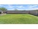 A large fenced-in backyard features green grass, a cinder block wall, and minimal landscaping at 3597 E Henson St, San Tan Valley, AZ 85140
