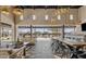 Bright and airy clubhouse boasts comfortable seating, a long table, and views of the refreshing pool area at 3597 E Henson St, San Tan Valley, AZ 85140