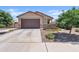 Charming single-story home featuring a well-kept lawn, stone accents, and a two-car garage at 3597 E Henson St, San Tan Valley, AZ 85140