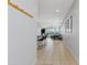 Bright hallway with tile flooring, coat rack, and views into the open-concept living and dining areas at 3597 E Henson St, San Tan Valley, AZ 85140