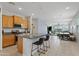 Open kitchen with granite countertops, stainless steel appliances, and breakfast bar seating at 3597 E Henson St, San Tan Valley, AZ 85140