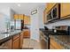 Stylish kitchen featuring stainless steel appliances, granite counters, and ample cabinet space at 3597 E Henson St, San Tan Valley, AZ 85140