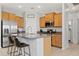 Well-lit kitchen with granite countertops, stainless steel appliances, and island with bar seating at 3597 E Henson St, San Tan Valley, AZ 85140