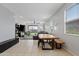 Open-concept living space with dining area, tile flooring, and abundant natural light at 3597 E Henson St, San Tan Valley, AZ 85140