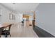 Open floor plan reveals living room leading into kitchen, all featuring neutral walls and tile flooring at 3597 E Henson St, San Tan Valley, AZ 85140