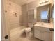 Bathroom featuring tiled shower over tub, with a toilet and vanity at 4034 E Anderson Dr, Phoenix, AZ 85032