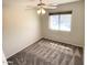 Carpeted bedroom with a ceiling fan and a window providing ample natural light at 4034 E Anderson Dr, Phoenix, AZ 85032