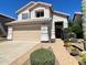 Charming two-story home with desert landscaping, brick walkway, and attached two-car garage at 4034 E Anderson Dr, Phoenix, AZ 85032