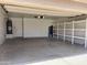 Garage featuring concrete floors, overhead lighting, and built-in shelving at 4034 E Anderson Dr, Phoenix, AZ 85032