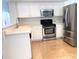 The kitchen has stainless steel appliances, white cabinets, and a tile floor at 4034 E Anderson Dr, Phoenix, AZ 85032