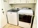 Laundry room featuring a modern washer and dryer, and white cabinets at 4034 E Anderson Dr, Phoenix, AZ 85032