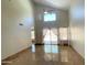Bright living room featuring vaulted ceilings, neutral walls, tile floors, and sliding doors to the backyard at 4034 E Anderson Dr, Phoenix, AZ 85032