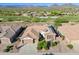 The aerial view of the property highlights desert landscaping, a three-car garage, and a well-maintained roof at 40613 N Candlewyck Ln, Anthem, AZ 85086