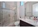 Well-lit bathroom with glass shower, neutral colors, and a stylish vanity at 40613 N Candlewyck Ln, Anthem, AZ 85086