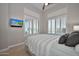 Comfortable bedroom featuring neutral tones, carpet flooring, and bright windows at 40613 N Candlewyck Ln, Anthem, AZ 85086
