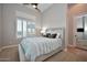 Cozy bedroom featuring neutral tones, carpet flooring, and bright windows at 40613 N Candlewyck Ln, Anthem, AZ 85086