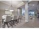 Formal dining room features stylish lighting, neutral tones, and seamless flow into the adjacent living areas at 40613 N Candlewyck Ln, Anthem, AZ 85086