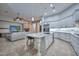 Open-concept kitchen with a large island and stainless steel appliances flows seamlessly into the living area at 40613 N Candlewyck Ln, Anthem, AZ 85086