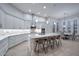 Bright kitchen featuring white cabinets, a granite island with seating, and modern appliances, perfect for entertaining at 40613 N Candlewyck Ln, Anthem, AZ 85086