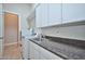 Efficient laundry room with modern washer and dryer, ample counter space, and overhead cabinets for storage at 40613 N Candlewyck Ln, Anthem, AZ 85086