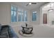 Bright living room with modern furniture, including a leather sofa and stylish coffee table, with large windows at 40613 N Candlewyck Ln, Anthem, AZ 85086