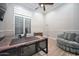 Well-lit home office featuring a modern desk, comfortable chair, and ample natural light from a large window at 40613 N Candlewyck Ln, Anthem, AZ 85086