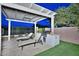 Outdoor kitchen and lounge area with built-in grill, perfect for outdoor cooking and enjoying the scenic backyard at 40613 N Candlewyck Ln, Anthem, AZ 85086