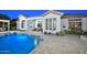 Beautiful backyard pool with access to the home and an outdoor living space, perfect for entertaining and relaxing at 40613 N Candlewyck Ln, Anthem, AZ 85086