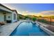 Resort-style pool with a tranquil waterfall feature and mountain views, perfect for relaxation and outdoor enjoyment at 40613 N Candlewyck Ln, Anthem, AZ 85086