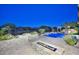 Inviting backyard pool with a fire pit and desert landscaping, ideal for evening relaxation and entertaining at 40613 N Candlewyck Ln, Anthem, AZ 85086