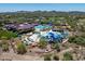Aerial view of the community featuring pools, water slides, club house, sport fields, and green spaces at 4230 W Palace Station Rd, New River, AZ 85087