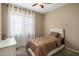 Comfortable bedroom with neutral walls, carpet flooring, ceiling fan, and natural light from the window at 4230 W Palace Station Rd, New River, AZ 85087