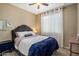 Comfortable bedroom with neutral walls, carpet flooring, ceiling fan, and natural light from the window at 4230 W Palace Station Rd, New River, AZ 85087
