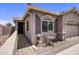 Inviting home exterior with a quaint seating area, desert landscaping, and a welcoming entryway at 4230 W Palace Station Rd, New River, AZ 85087