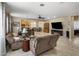Spacious living room with tile flooring, a ceiling fan, fireplace, and comfortable furnishings at 4230 W Palace Station Rd, New River, AZ 85087