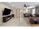 Bright living room featuring tile floors, fireplace, and a large flat screen TV at 4230 W Palace Station Rd, New River, AZ 85087