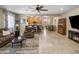Open-concept living and dining area featuring tile floors, ceiling fan, and seamless kitchen access at 4230 W Palace Station Rd, New River, AZ 85087