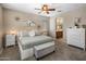 Inviting primary bedroom with ceiling fan, neutral tones, and an ensuite bathroom at 4230 W Palace Station Rd, New River, AZ 85087