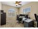 Spacious office features multiple monitors and chairs, large windows, and carpet flooring at 4230 W Palace Station Rd, New River, AZ 85087