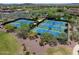 Aerial view of community tennis courts, showcasing well-maintained blue courts and verdant landscaping in a desert setting at 4230 W Palace Station Rd, New River, AZ 85087