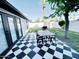Inviting backyard patio with a checkered tile floor, complete with a dining table and grill, perfect for entertaining at 541 W Marlette Ave, Phoenix, AZ 85013