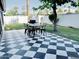 Charming backyard patio with black and white tile, complete with an outdoor dining set and lush green lawn at 541 W Marlette Ave, Phoenix, AZ 85013