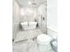 Modern bathroom with a luxurious soaking tub, sleek glass shower, and elegant marble tile throughout at 541 W Marlette Ave, Phoenix, AZ 85013