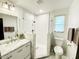 Modern bathroom featuring a glass enclosed shower, marble vanity, and updated fixtures at 541 W Marlette Ave, Phoenix, AZ 85013