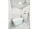 Contemporary bathroom showcasing a stylish soaking tub, glass shower, and sophisticated marble tiling at 541 W Marlette Ave, Phoenix, AZ 85013