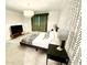 Spacious bedroom with modern wallpaper, tv, and comfortable bed at 541 W Marlette Ave, Phoenix, AZ 85013
