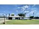 Charming single-story home featuring a lush green lawn, beautiful blue skies, and mature palm trees at 541 W Marlette Ave, Phoenix, AZ 85013
