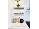 Close-up of kitchen counter, shelving, and decor with marble backsplash at 541 W Marlette Ave, Phoenix, AZ 85013