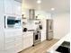 Bright kitchen featuring white cabinets, stainless steel appliances, and modern finishes, perfect for culinary enthusiasts at 541 W Marlette Ave, Phoenix, AZ 85013