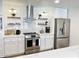 Well-equipped kitchen with stainless steel appliances, white cabinets, and elegant countertops at 541 W Marlette Ave, Phoenix, AZ 85013
